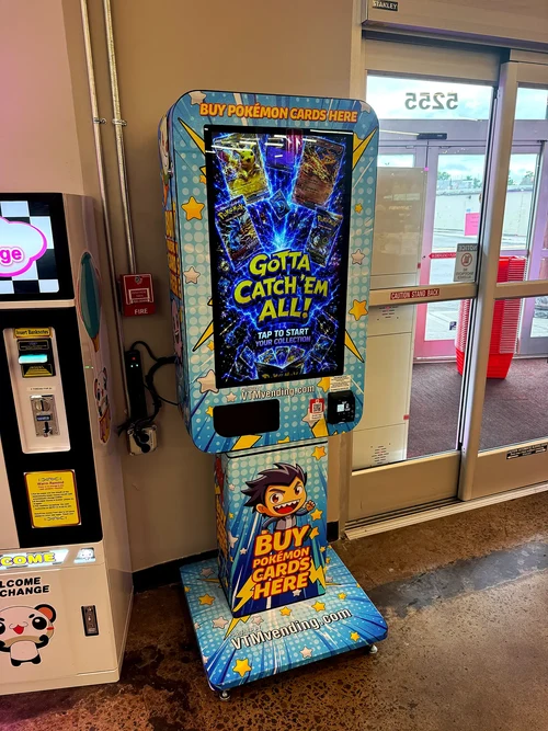 VTM Mini trading-card vending machine installed beside a retail entrance